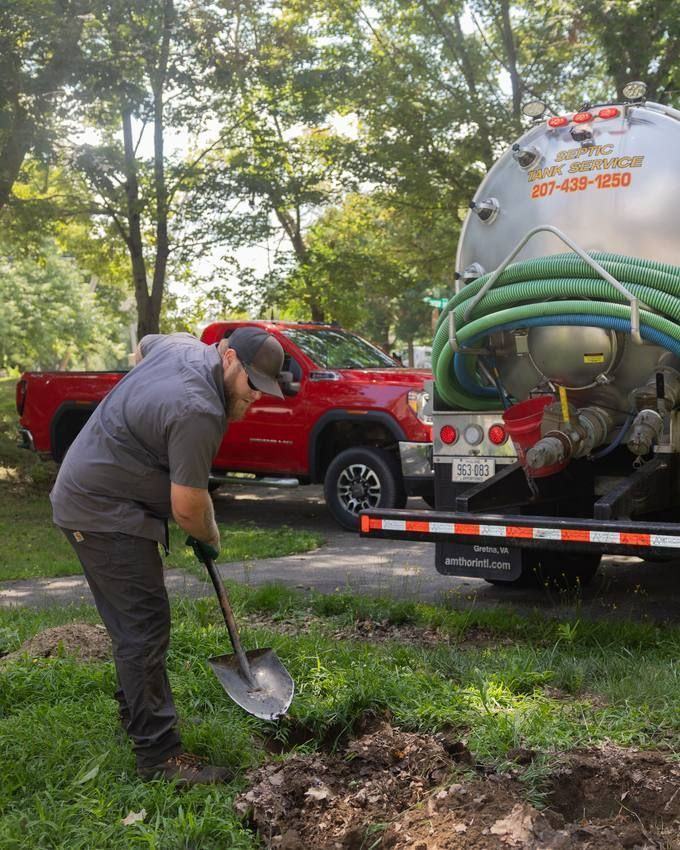A crew member digging to reach a tank lid.