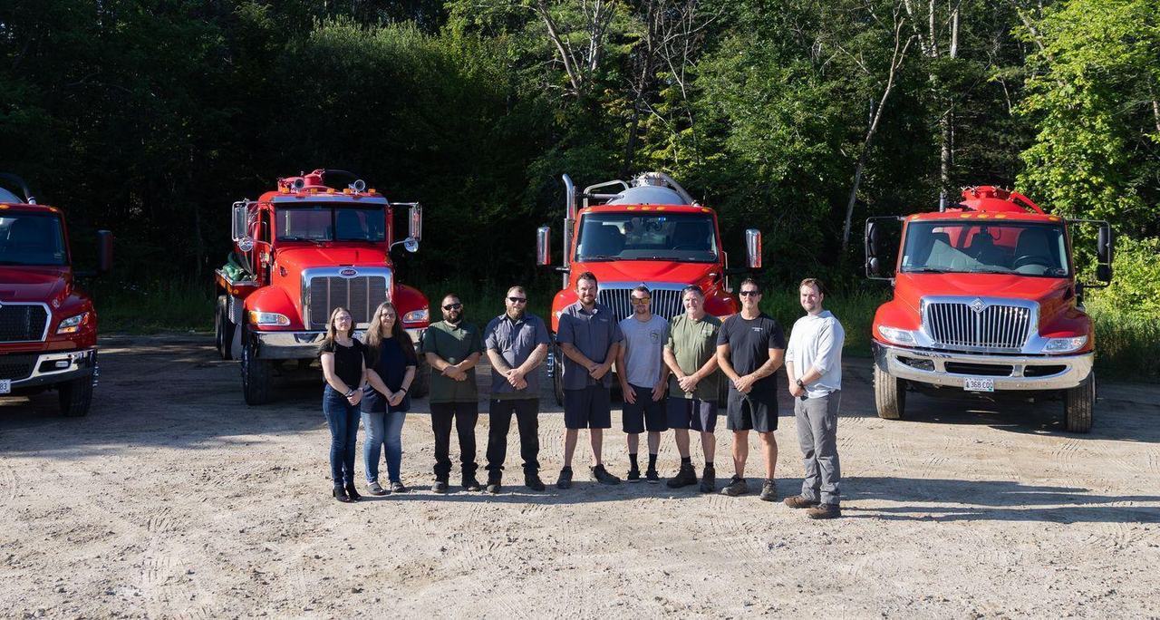 The Morgridge crew lined up in front of the fleet at the yard.