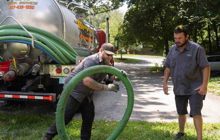 A Morgridge pump truck working a residential septic tank.