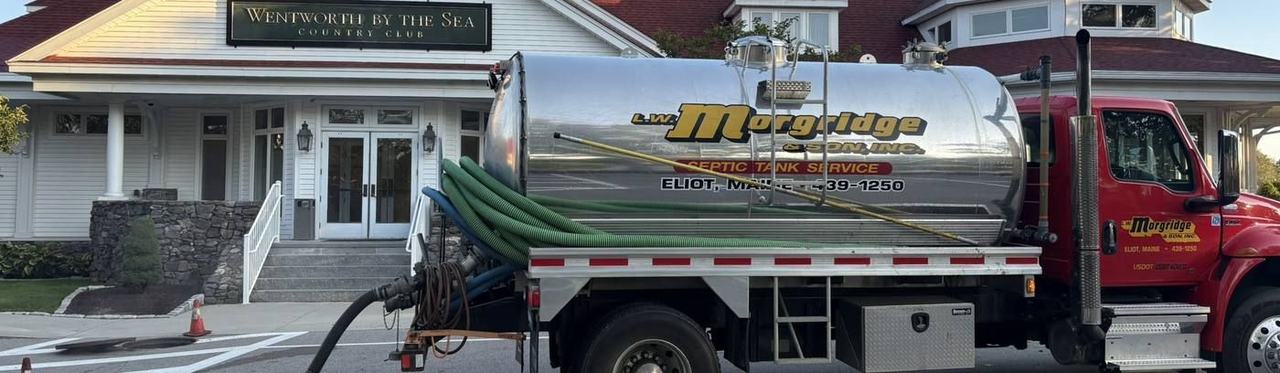 A Morgridge service truck lettered "Grease Traps Cleaned" parked at a commercial property.