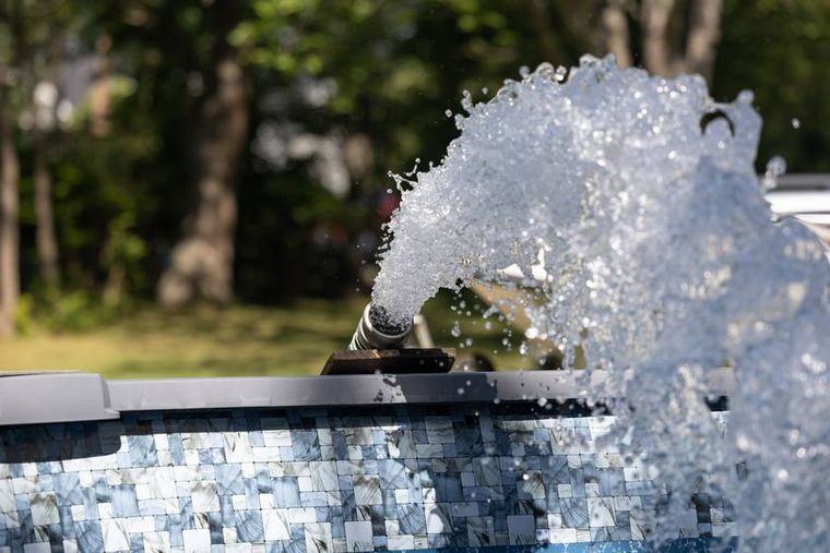 The dedicated clean-water tanker filling a backyard pool.