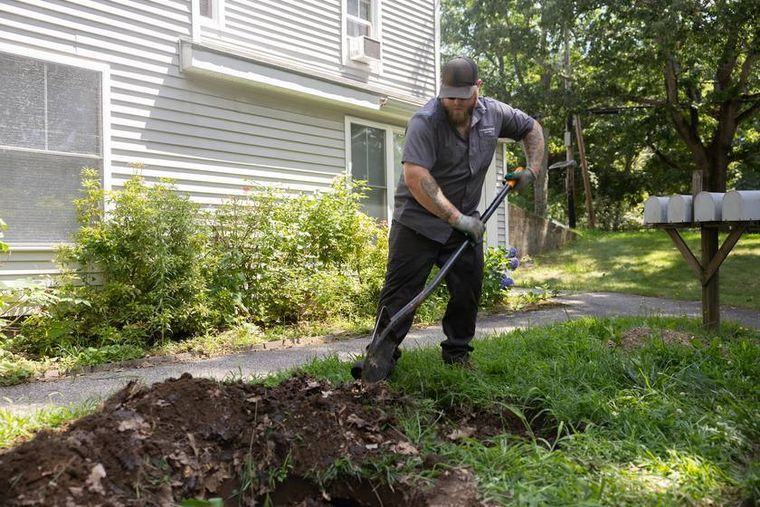 A Morgridge pump truck working a residential septic tank.