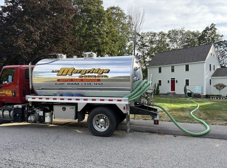A Morgridge pump truck parked at a house on a scheduled maintenance visit.