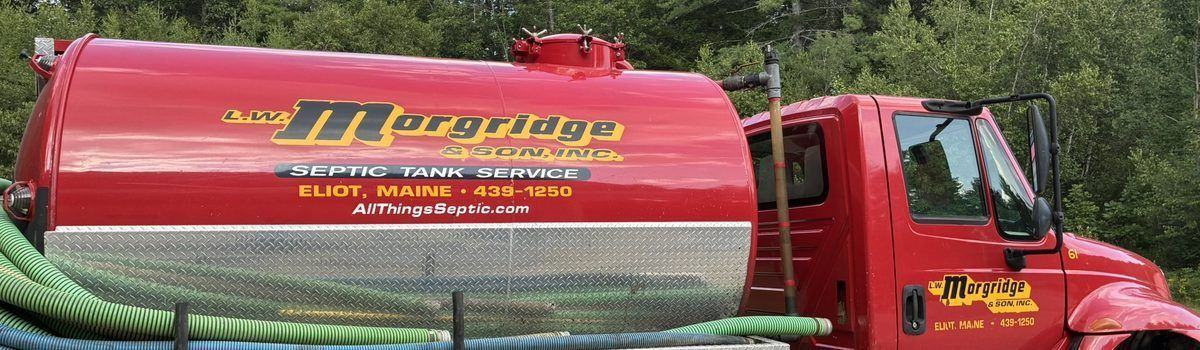 A septic riser with its cover set at ground level in a lawn, ready to be opened on a service call.