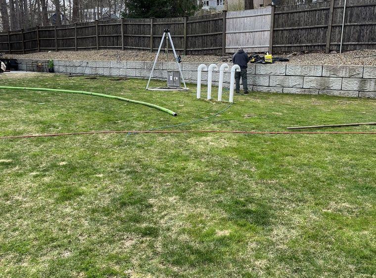 A riser and cover brought up to grade in a lawn.