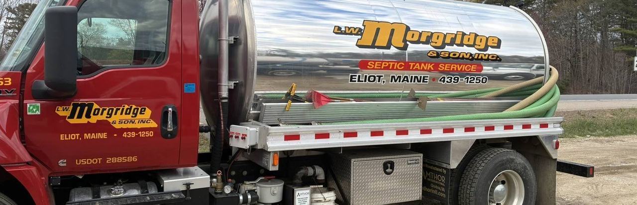 A Morgridge septic truck on a job with the suction hose run out.