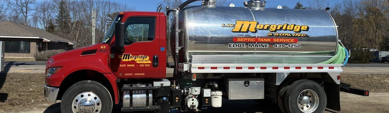 A Morgridge septic truck with a polished stainless tank parked at a job.