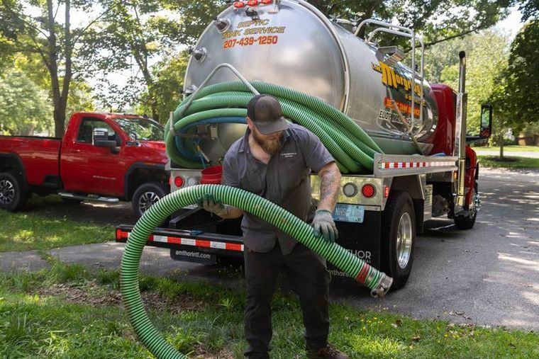 The suction hose run from the truck into the open tank while it is pumped down.
