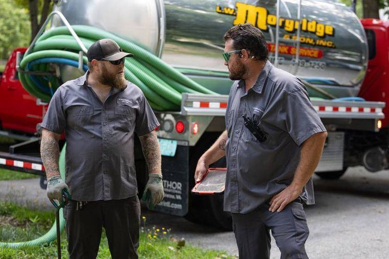 The technician talking through the condition of the tank with the homeowner before leaving.