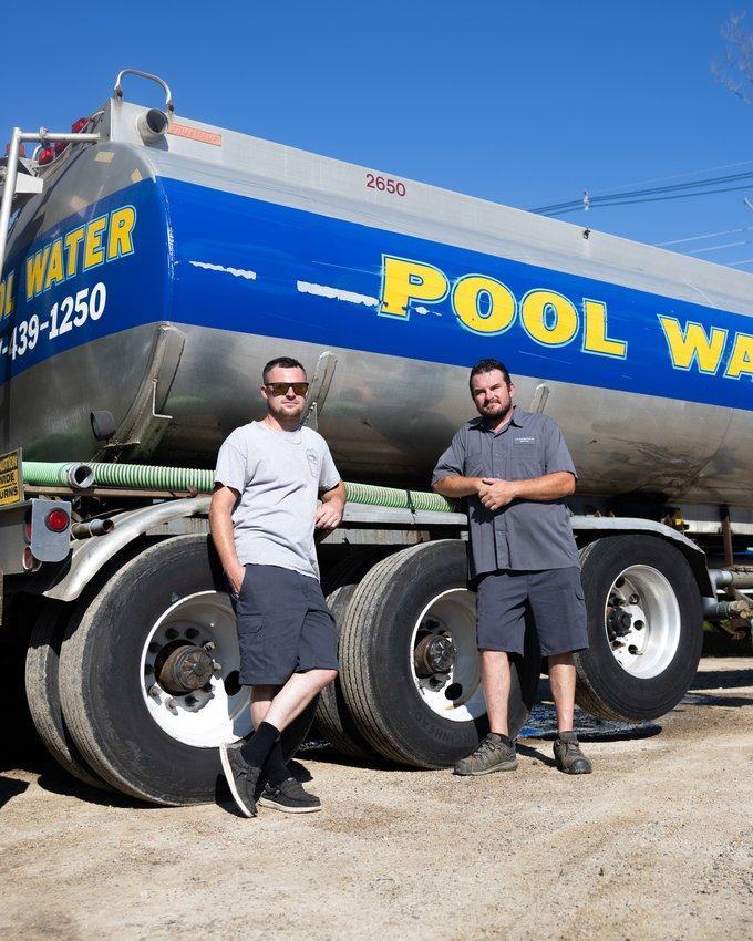 Two of the crew with the pool water tanker at the yard.
